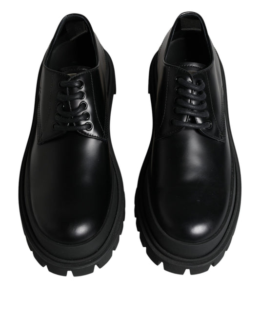 Pair of black leather lace-up shoes with white stripes on sides