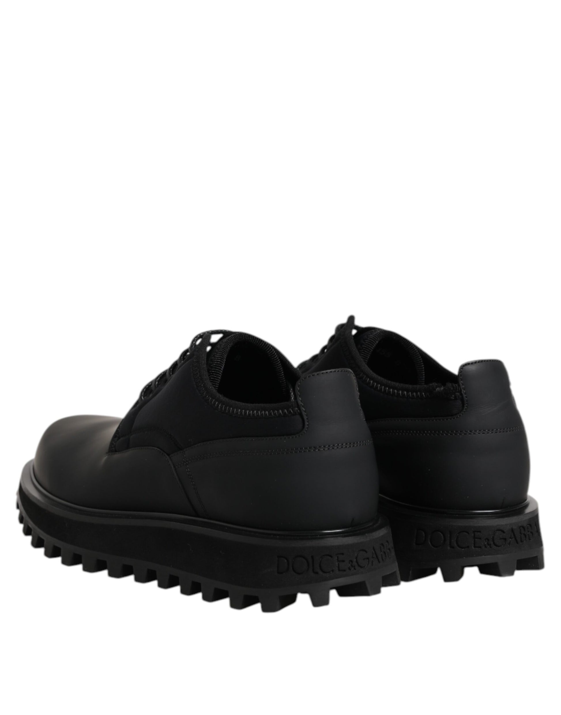 Pair of black leather lace-up shoes with rubber sole and textured design