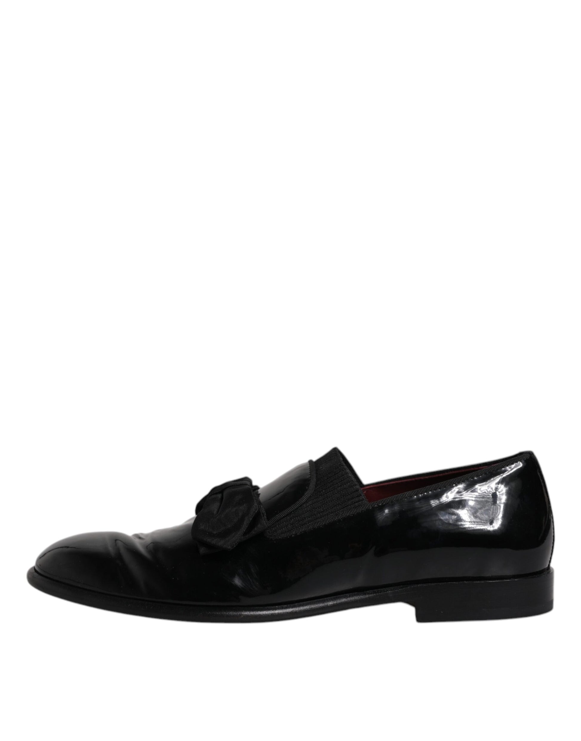 A pair of black leather loafers with a bow tie detail, designed for men's formal wear