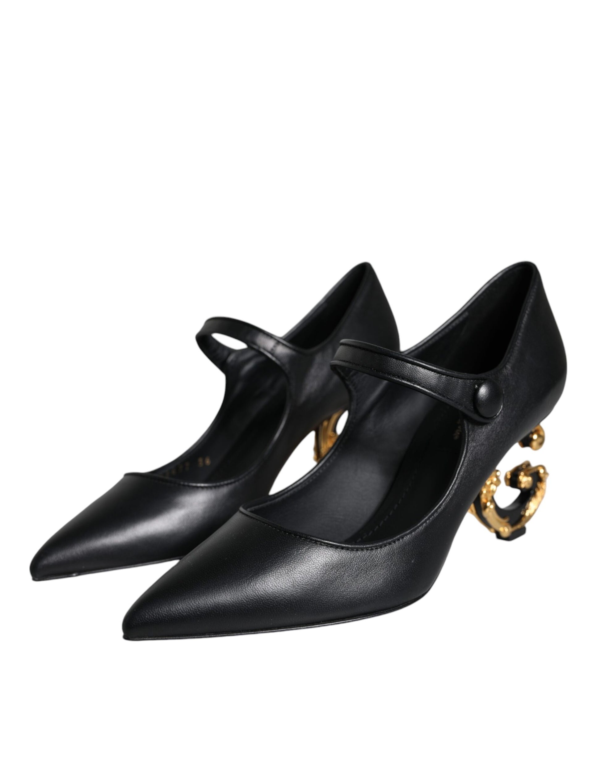 Pair of black high heel shoes with gold accents