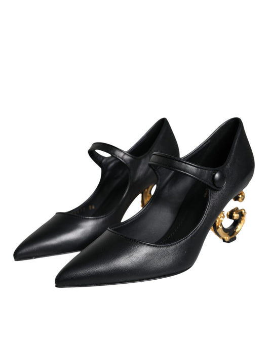 Pair of black high heel shoes with gold accents