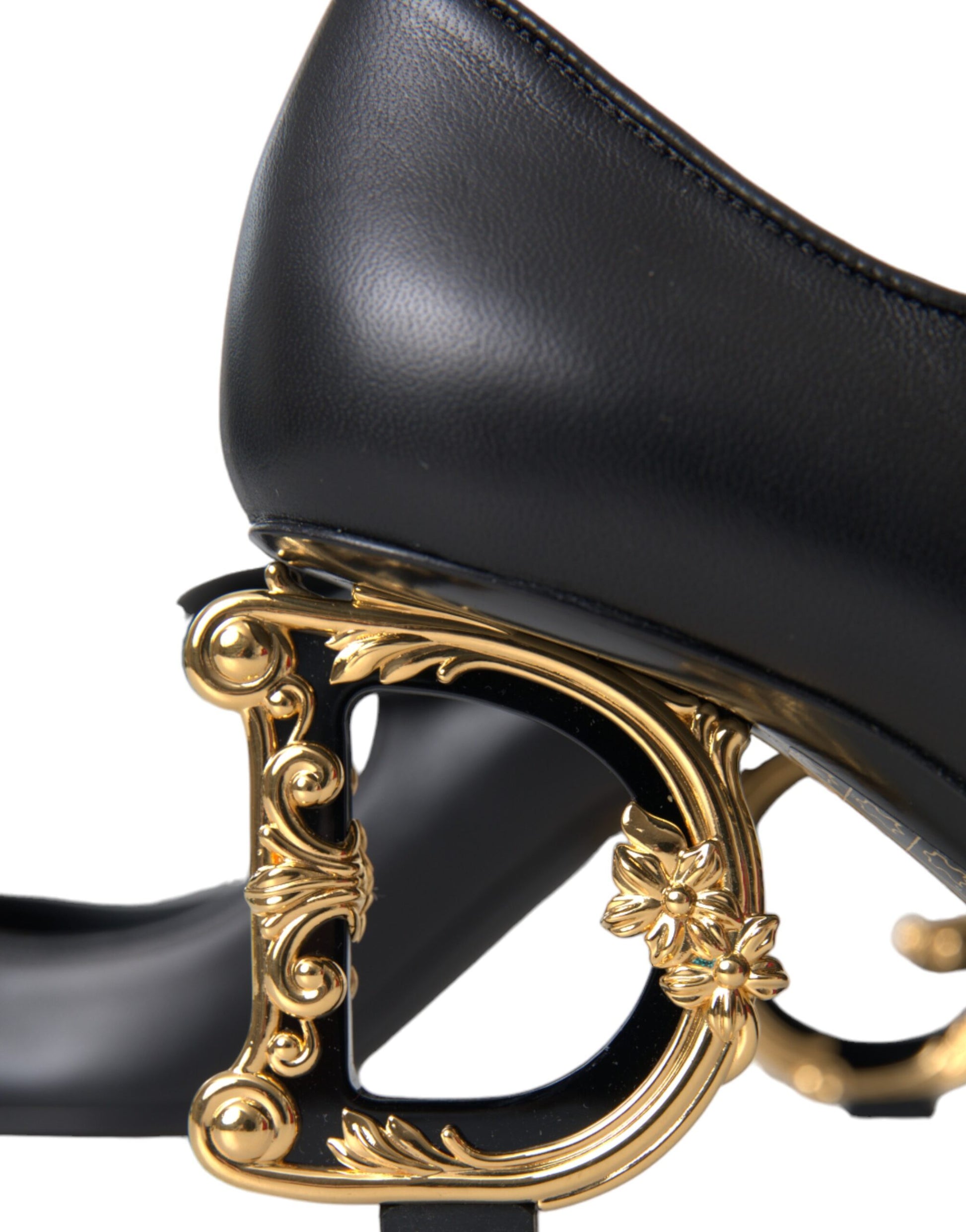 Black high heel shoe with gold accents