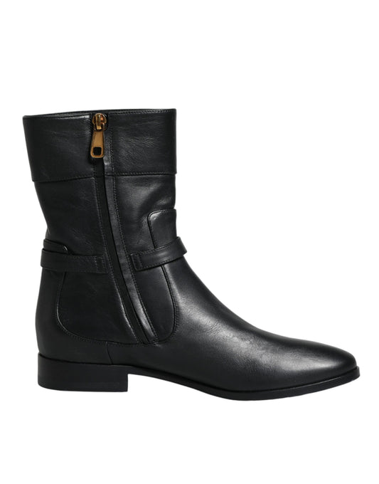 Black leather boot with gold zipper pull