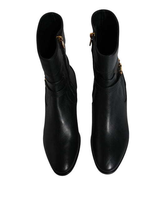 Pair of black leather boots with gold accents