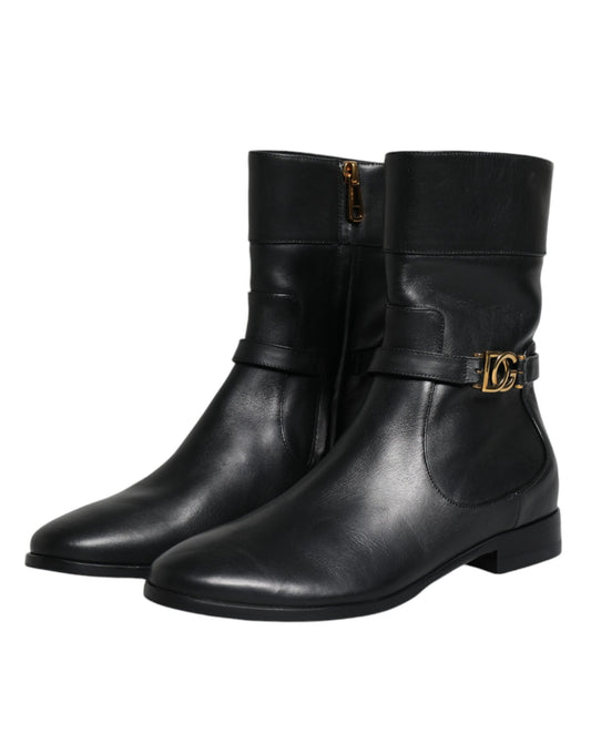 Pair of black leather boots with gold buckle