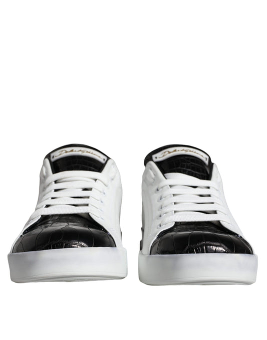 Pair of black leather sneakers with white laces and logo on side