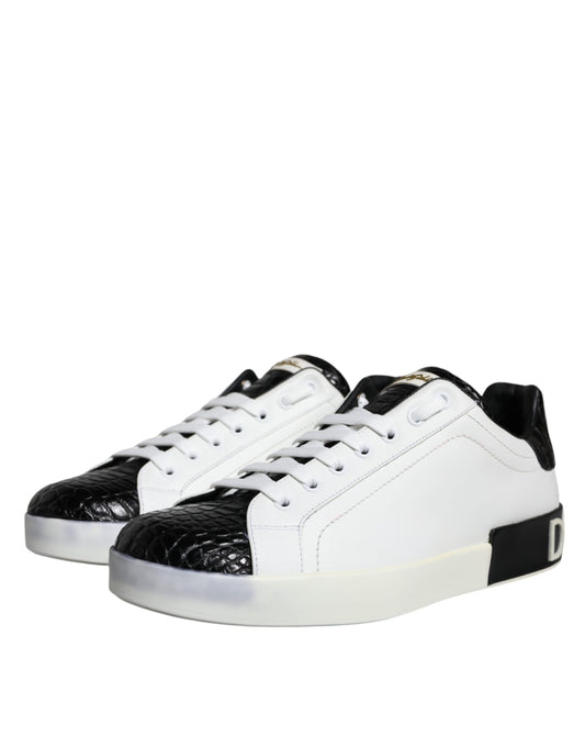A pair of black leather sneakers with white laces and a logo on the side