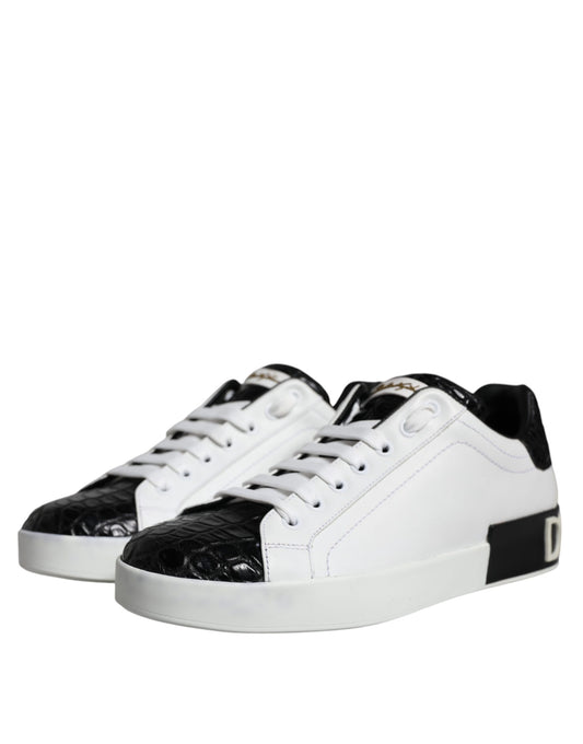 A pair of black leather sneakers with white laces and a logo on the side