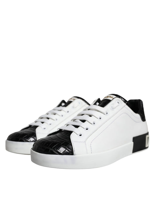 A pair of black leather sneakers with white laces and a logo on the side