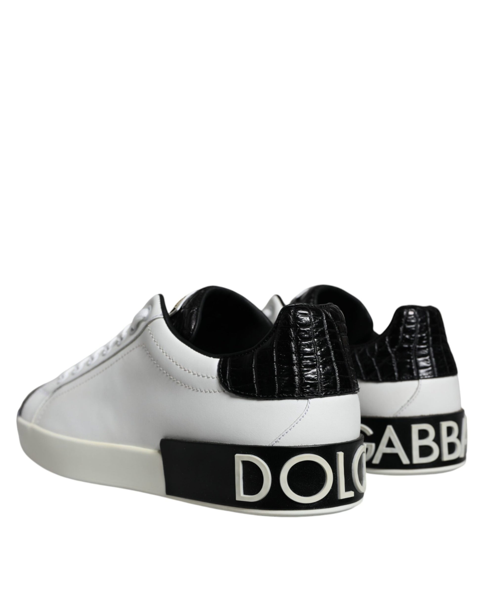 A pair of black leather sneakers with white soles and a logo on the side