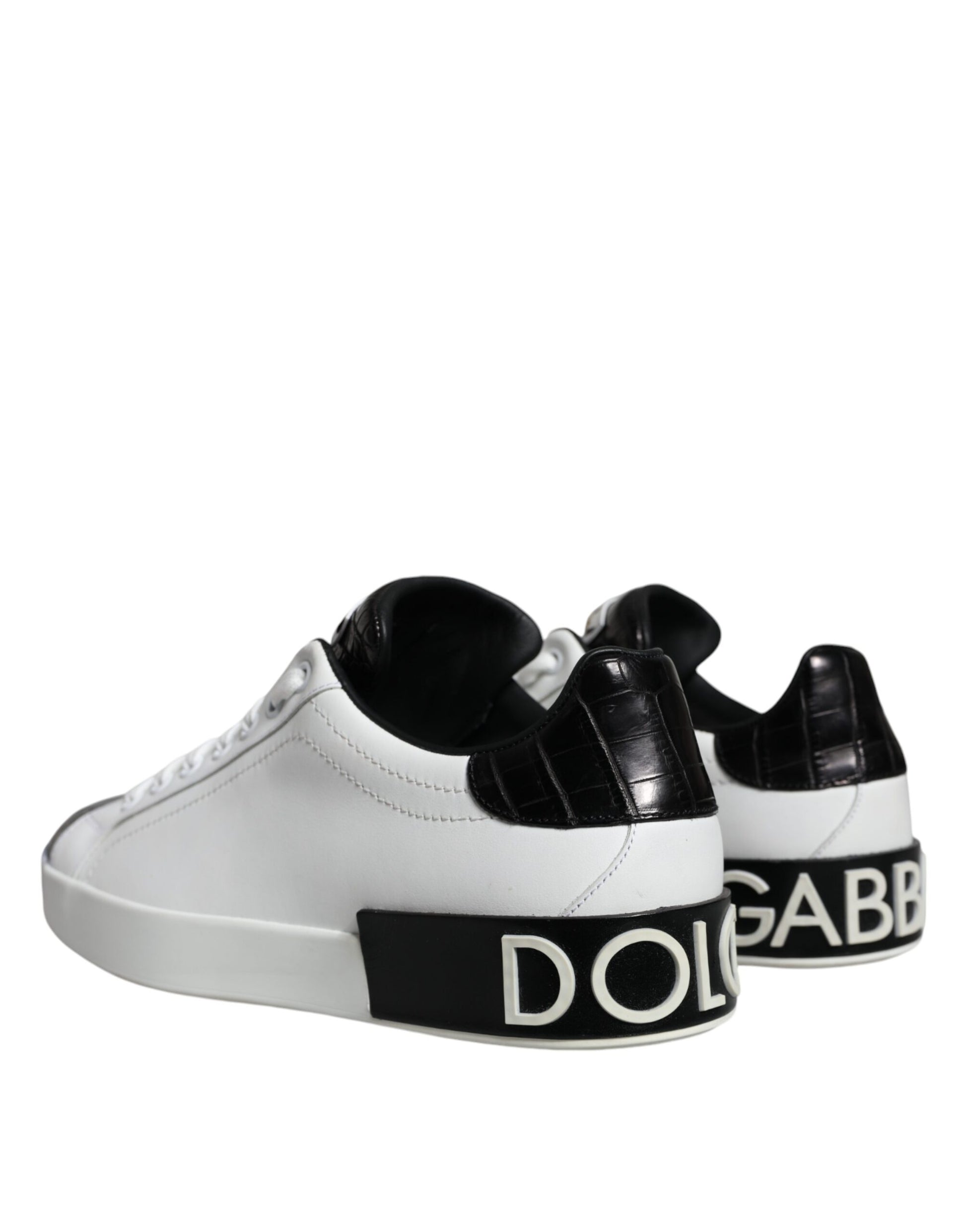 White sneakers with black leather accents and a logo on the side