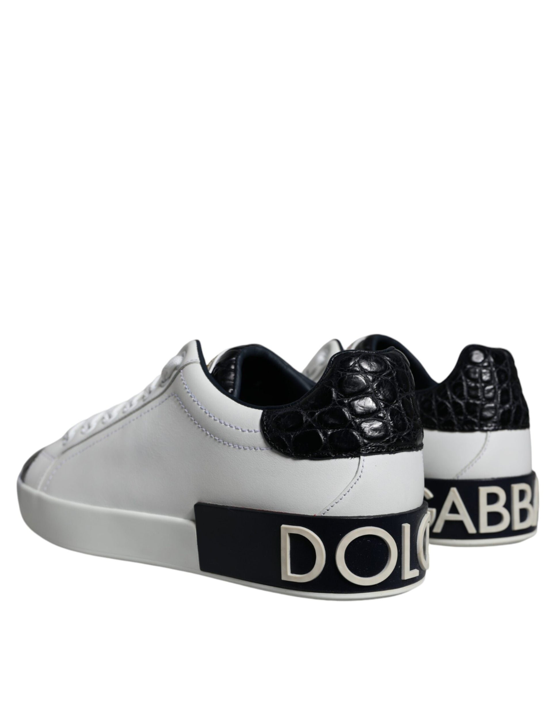 A pair of black leather sneakers with a logo on the side, featuring white laces and a white sole