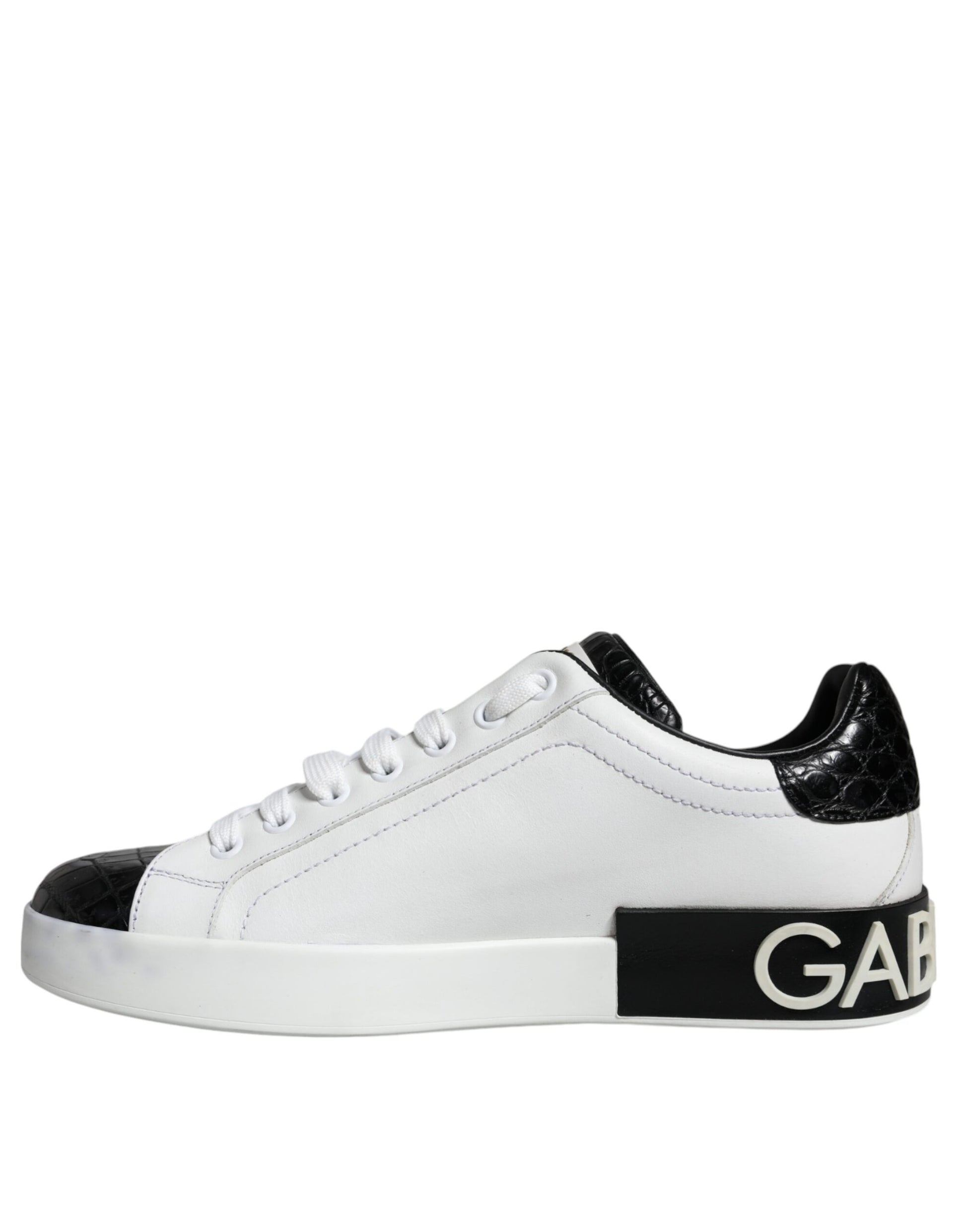 White sneakers with black leather accents and a logo on the side