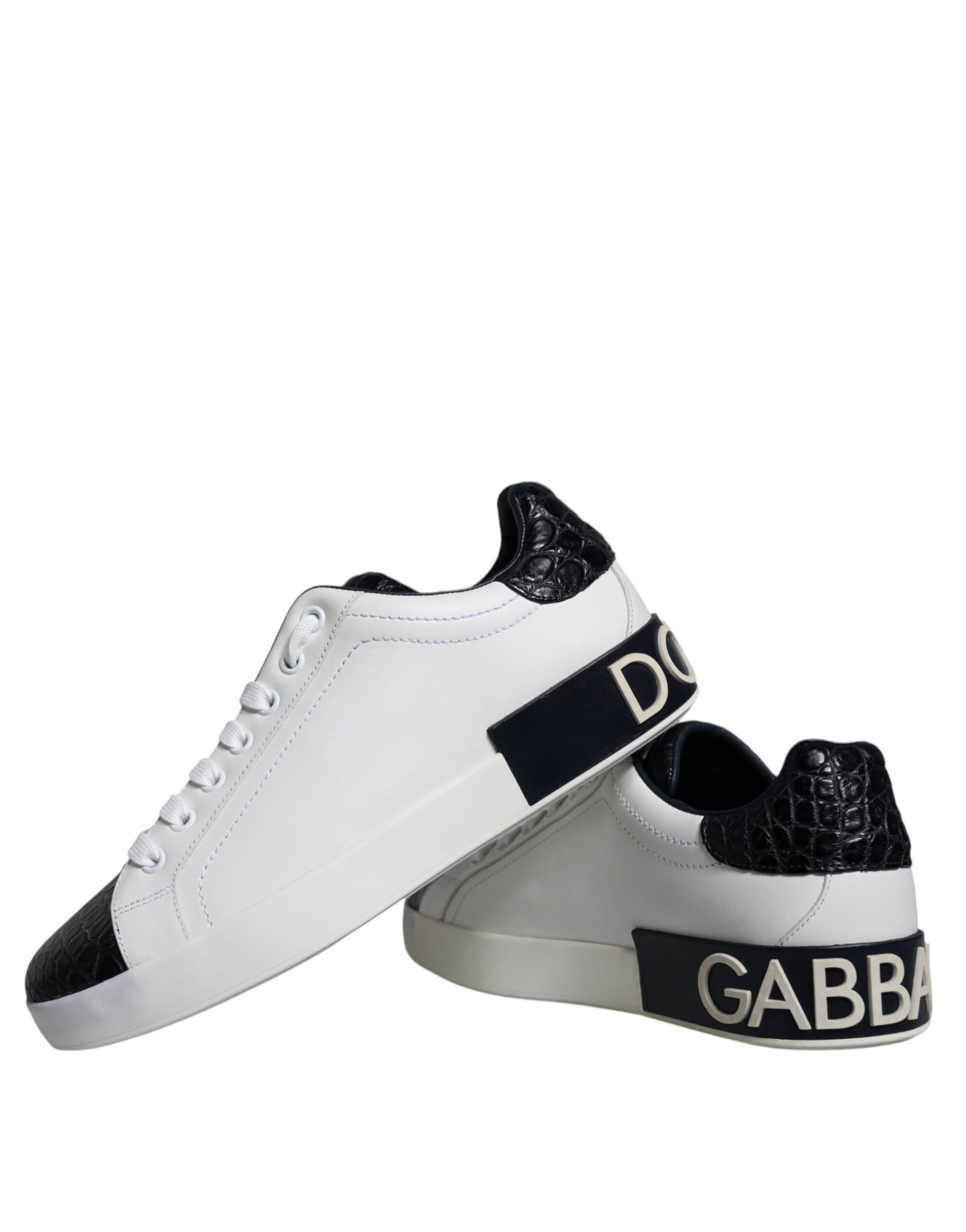 White sneakers with black leather accents and logo on side