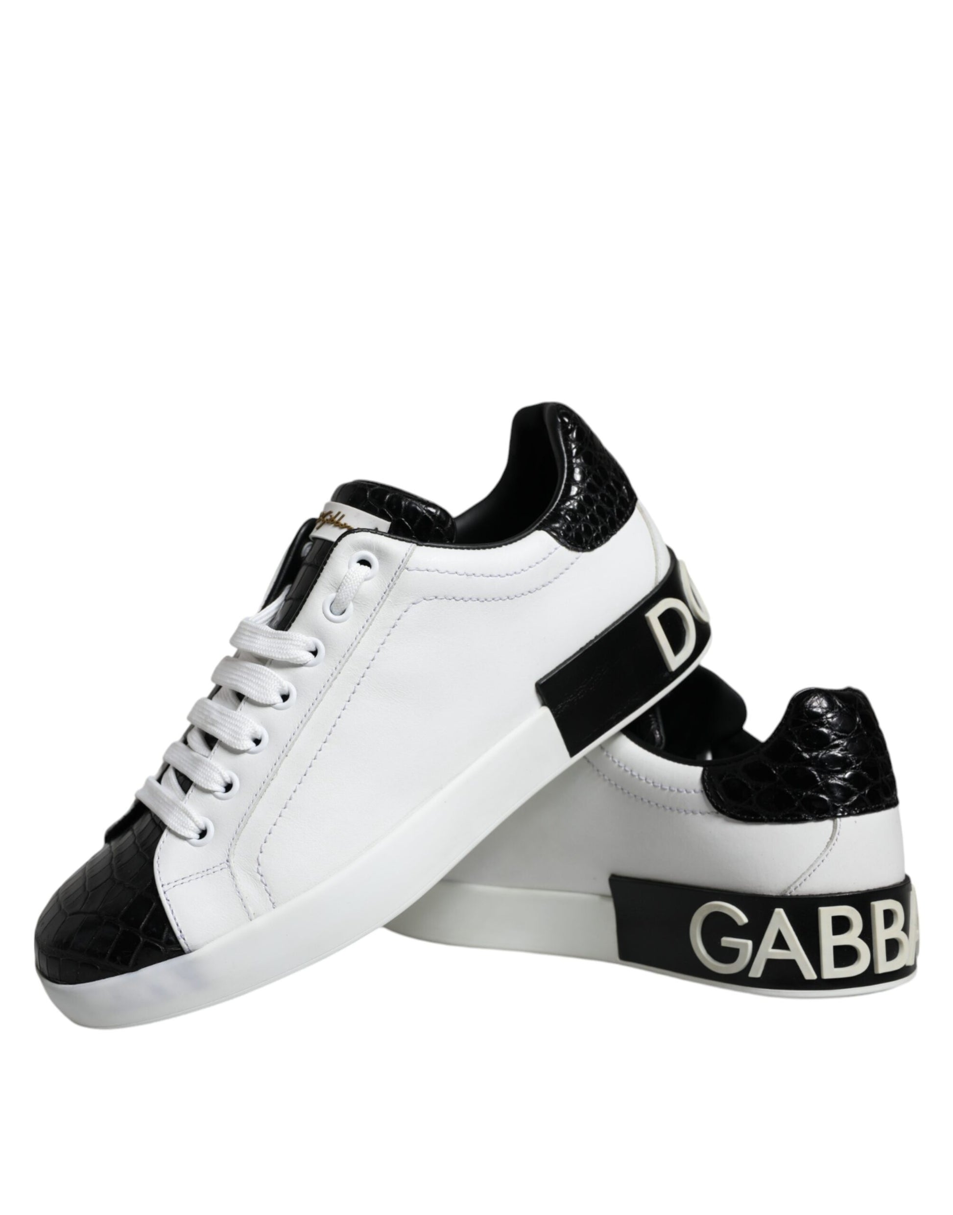 White sneakers with black laces, featuring a logo on the side and a black leather design