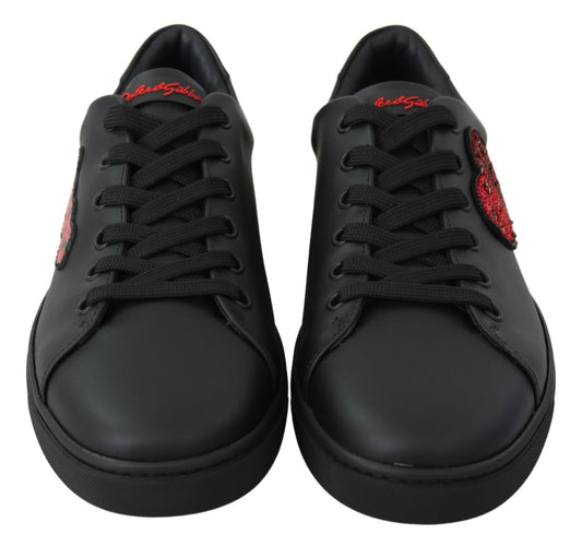 Pair of black sneakers with red laces and logo on side