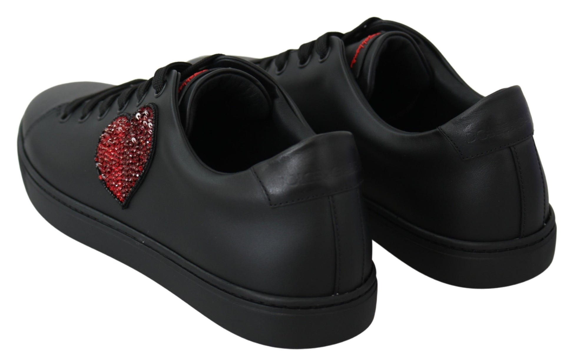 Pair of black sneakers with red heart embellishment on side