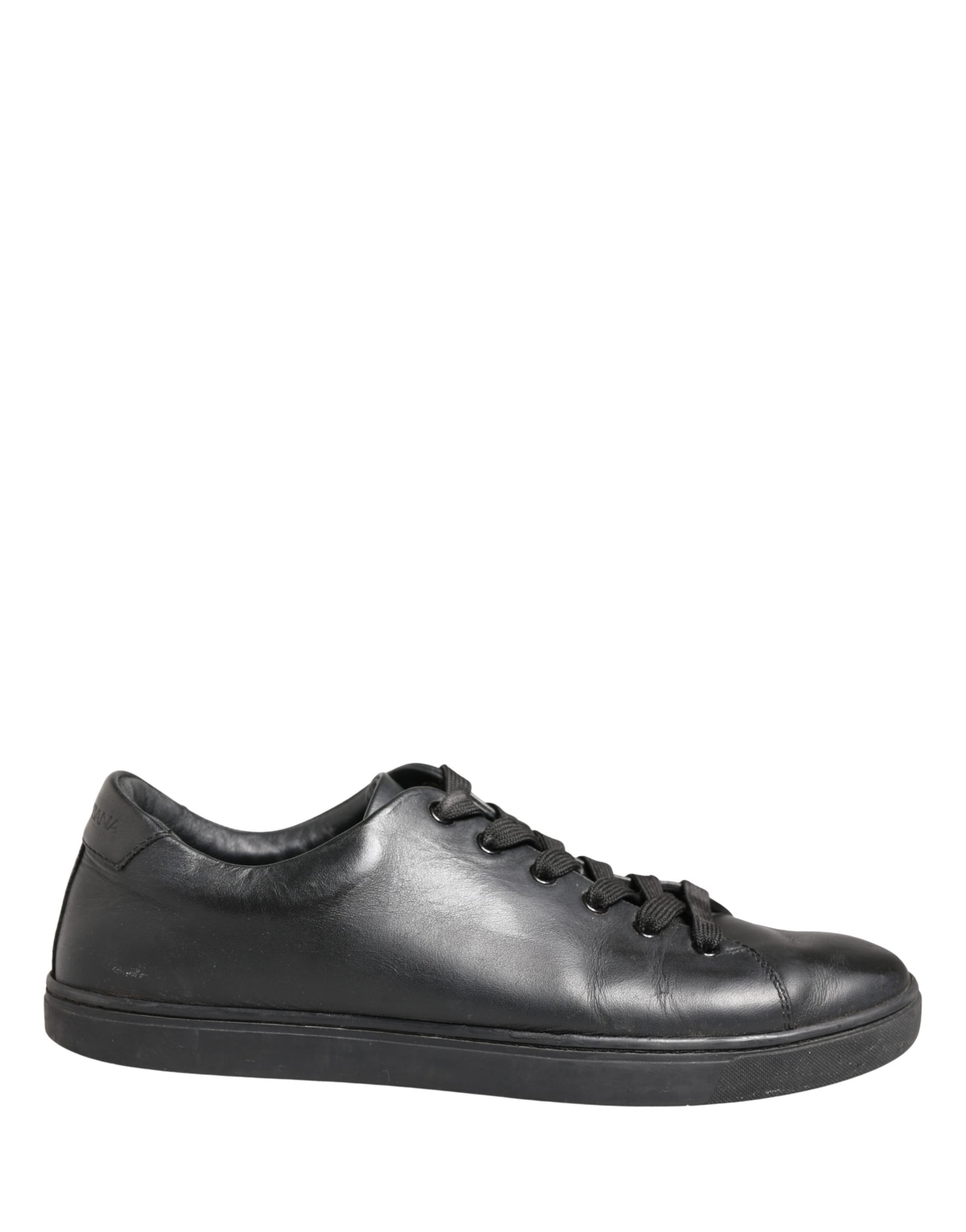 A pair of black leather lace-up sneakers with a low top, featuring the brand name "Dolce & Gabbana