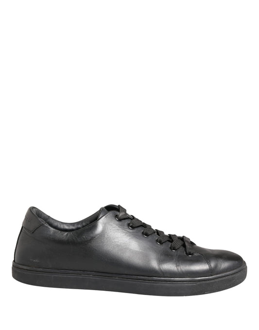 A pair of black leather lace-up sneakers with a low top, featuring the brand name "Dolce & Gabbana