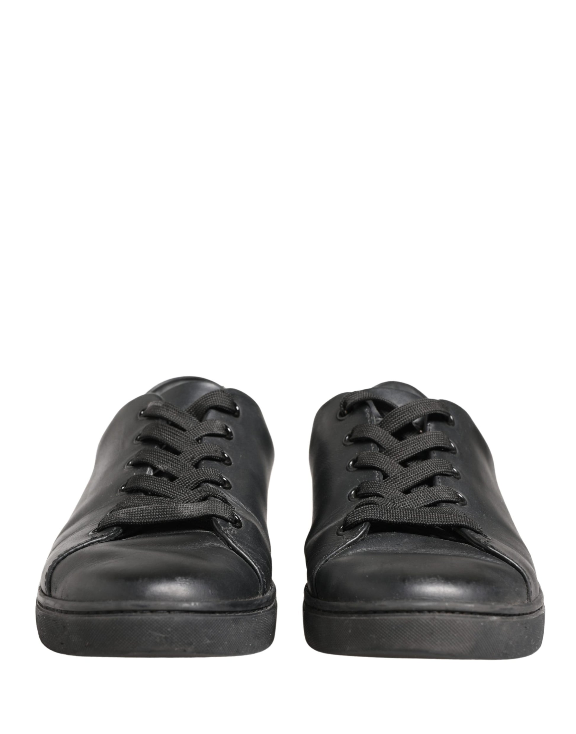 Pair of black leather lace-up sneakers with white soles