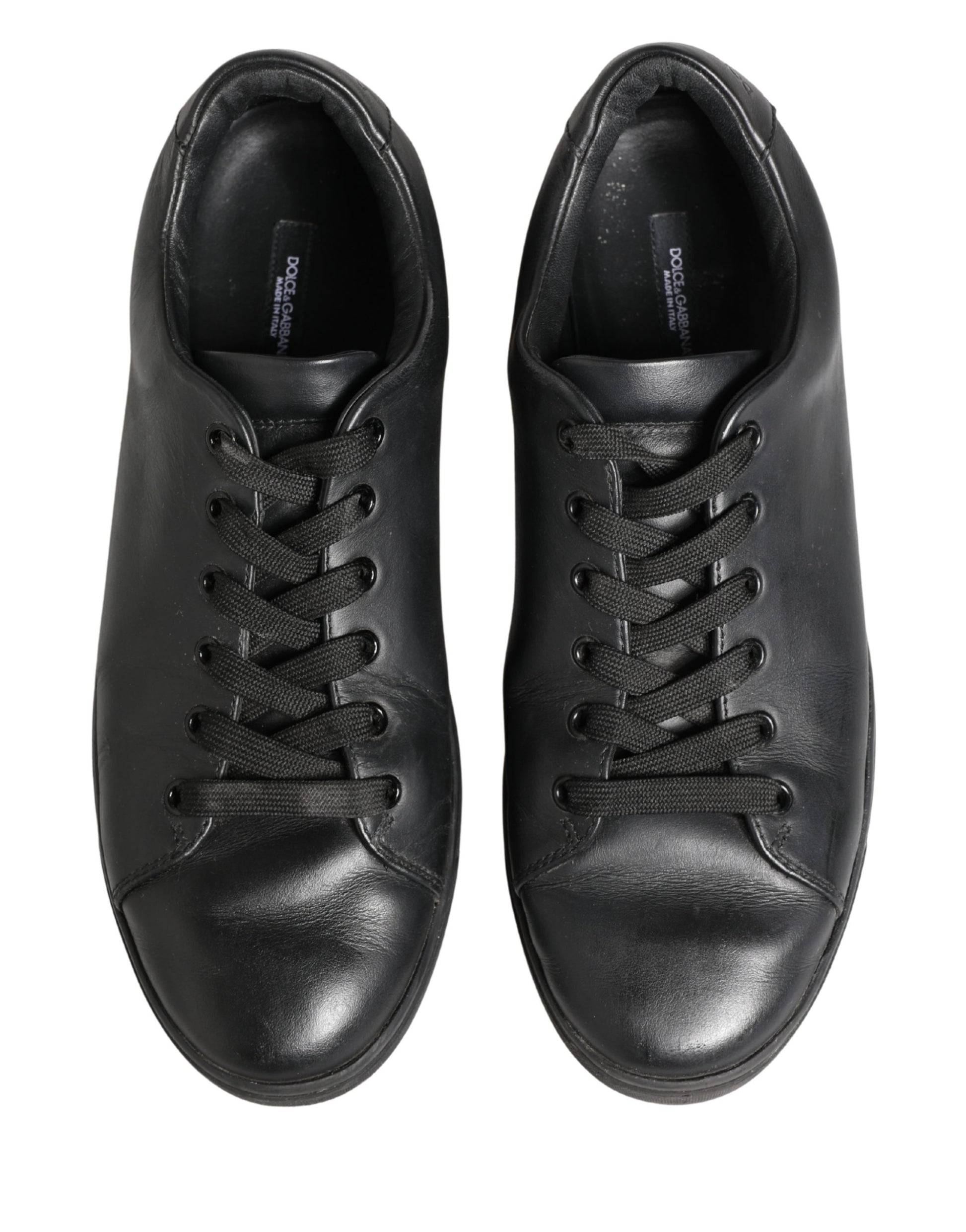 Pair of black leather lace-up sneakers with low top and visible stitching