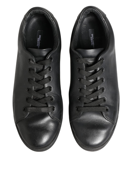 Pair of black leather lace-up sneakers with low top and visible stitching