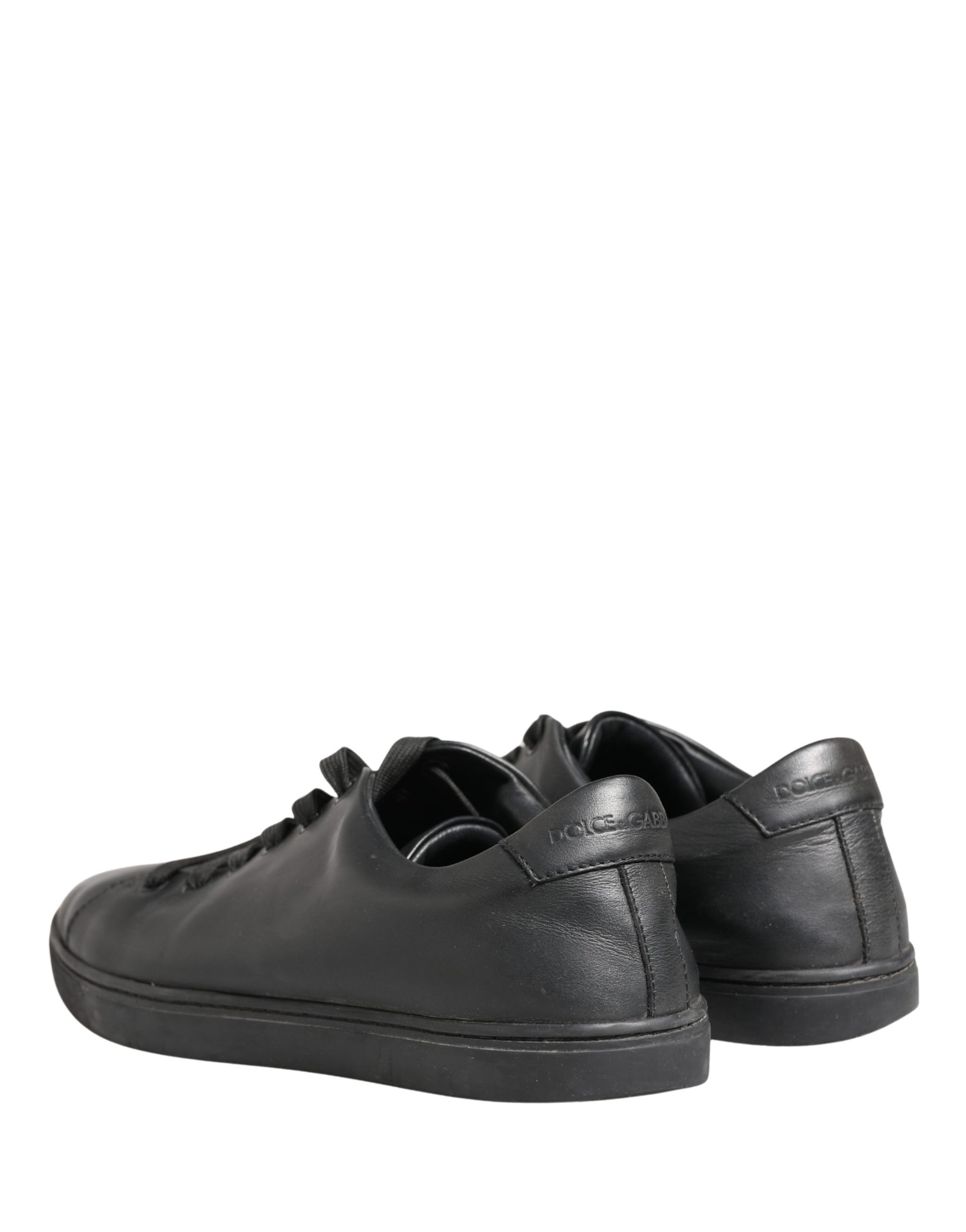 Pair of black leather lace-up sneakers with low top, featuring a shiny finish
