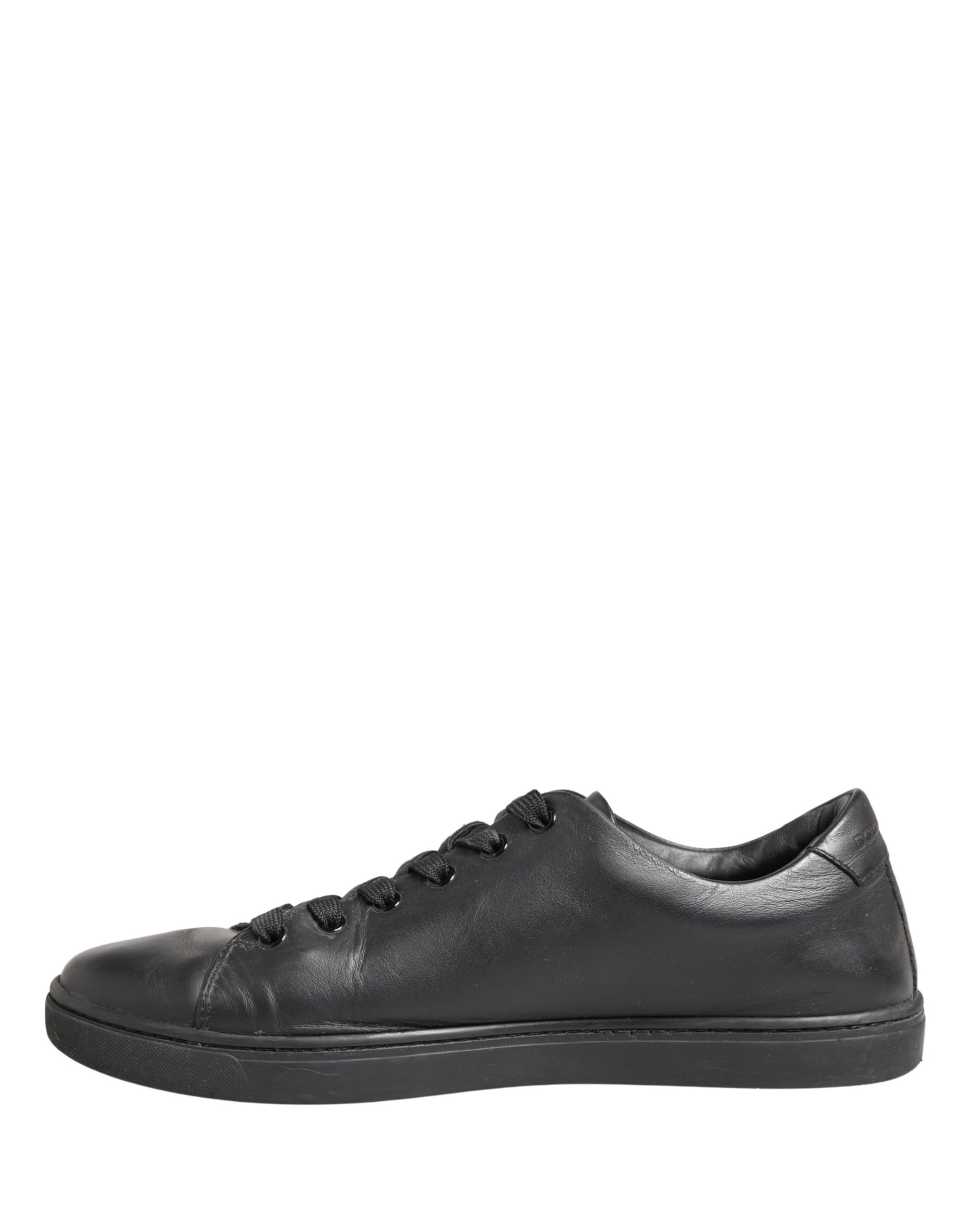 A pair of black leather lace-up sneakers with a low top, featuring the brand name "Dolce & Gabbana" on the side