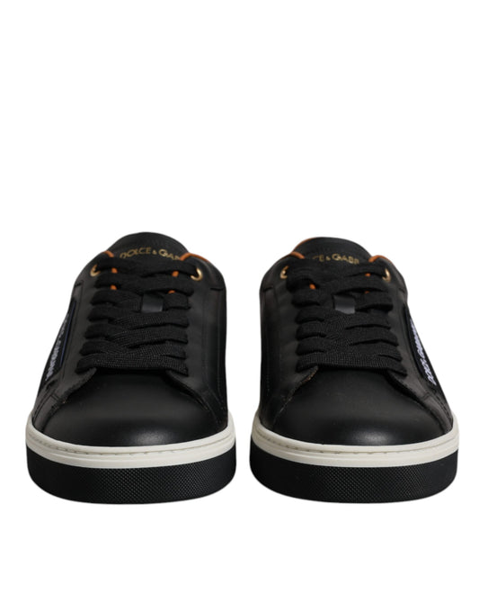 Pair of black sneakers with white soles and laces