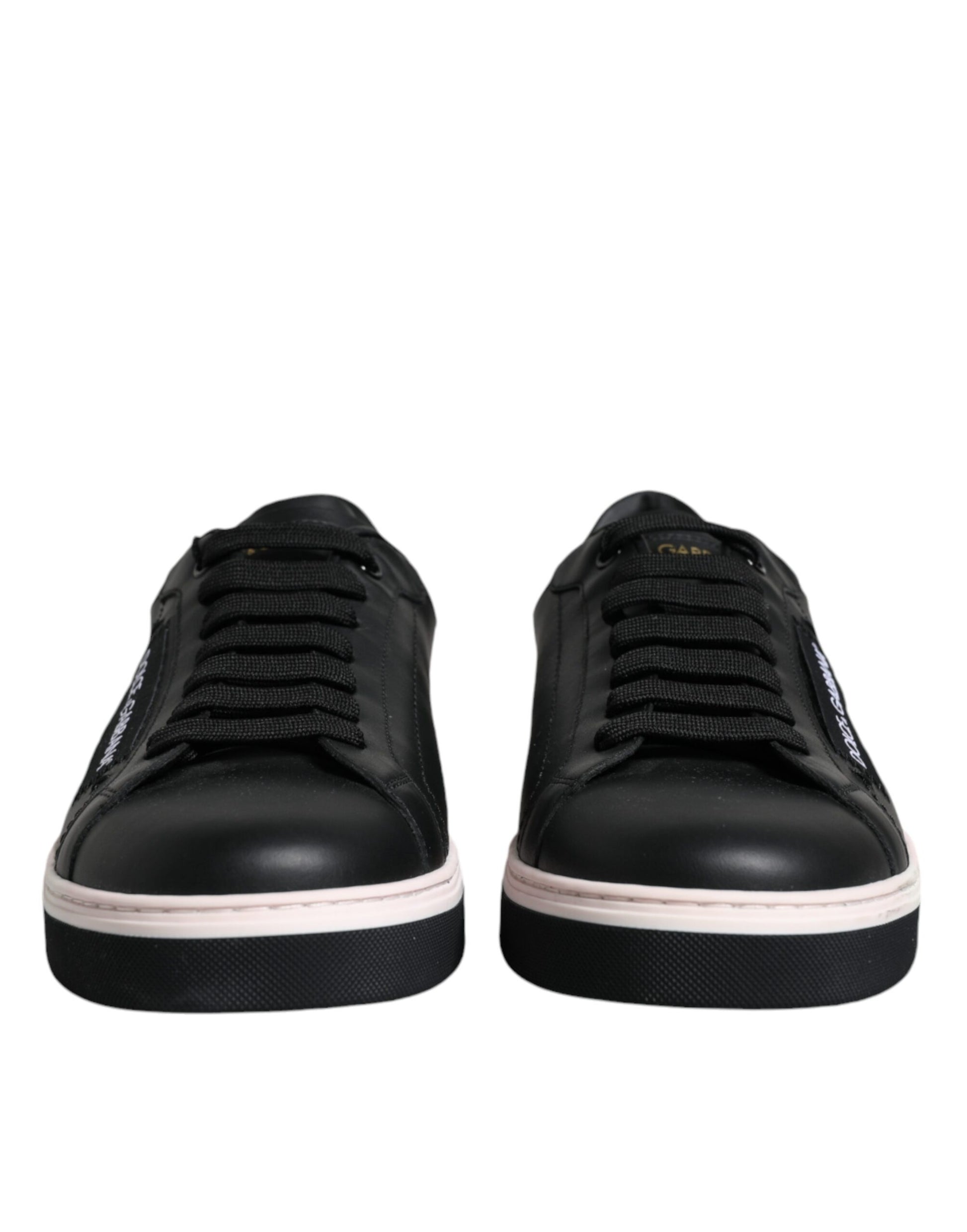 Pair of black sneakers with white soles and laces