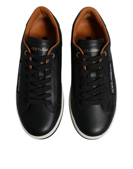 Pair of black and white sneakers with gold accents