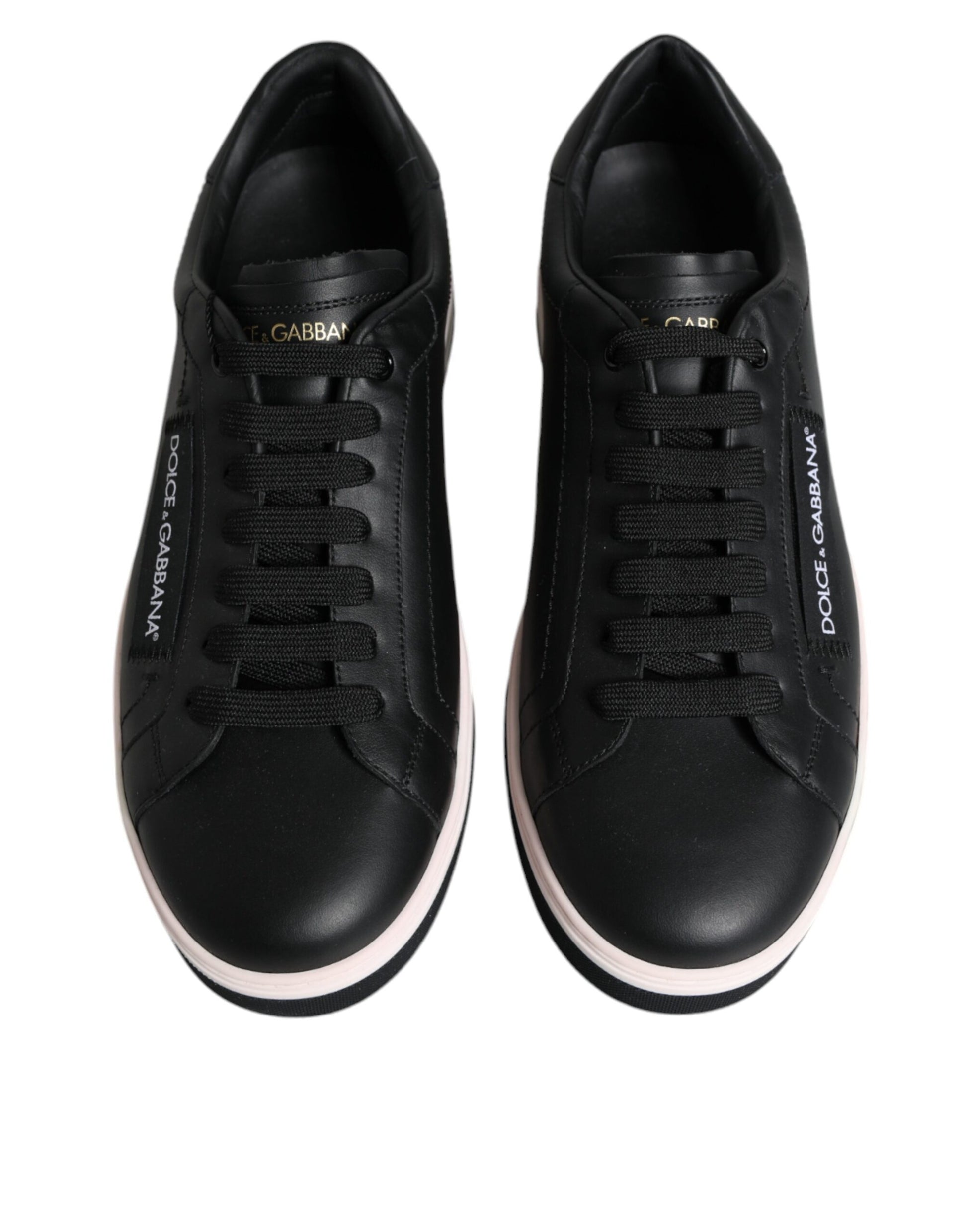 Pair of black sneakers with pink accents and white soles