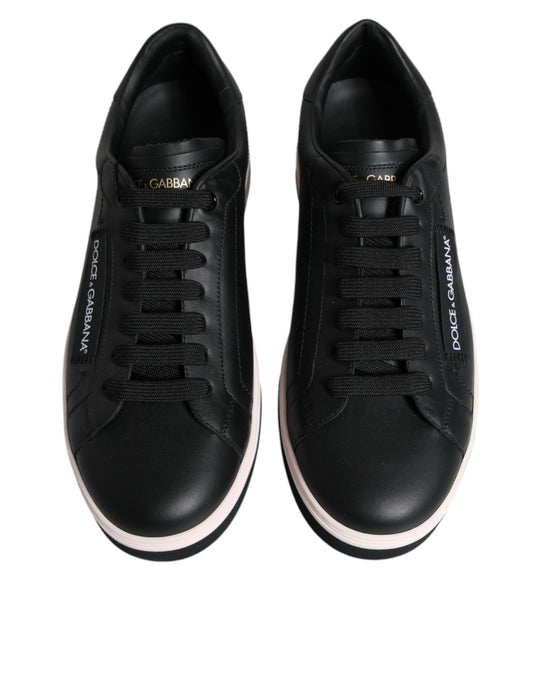 Pair of black sneakers with pink accents and white soles