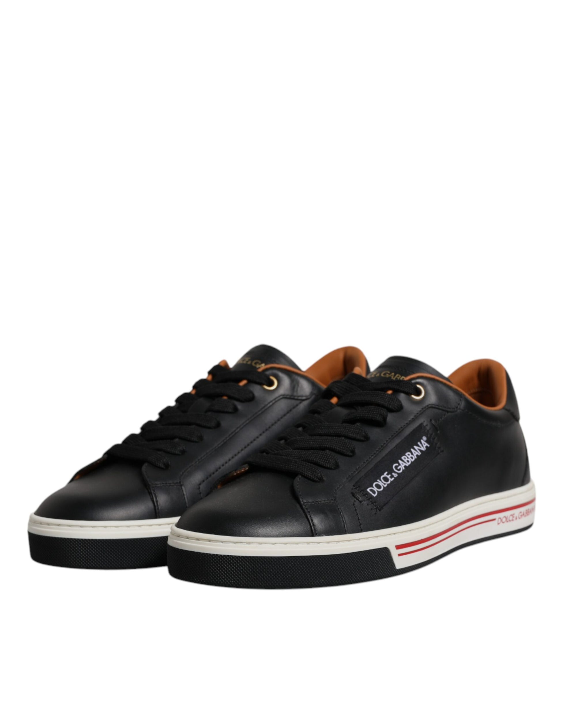 Pair of black sneakers with white sole and red stripe on side
