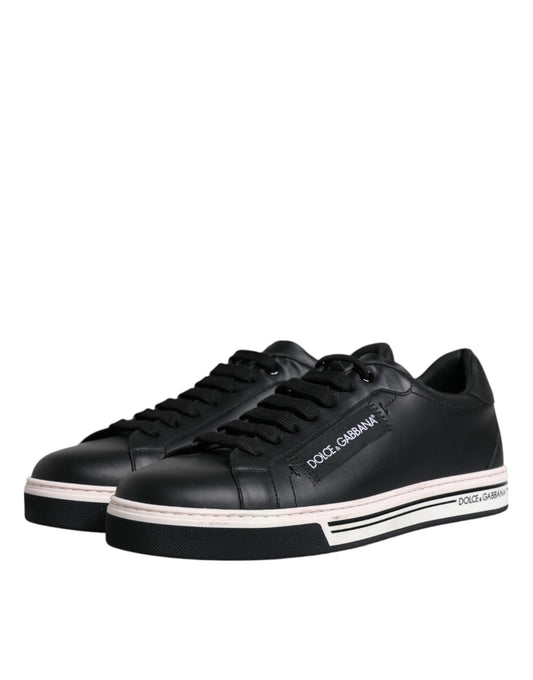 Pair of black sneakers with pink accents and white soles
