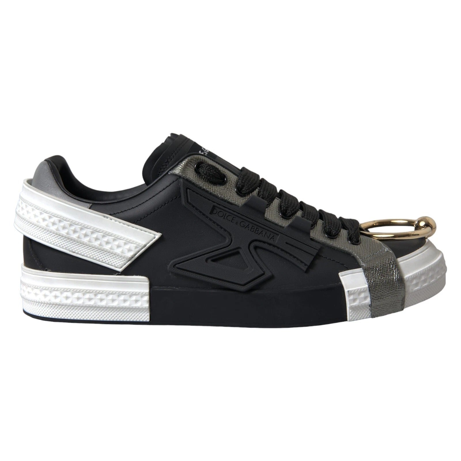Black sneaker with white sole and gold zipper pull