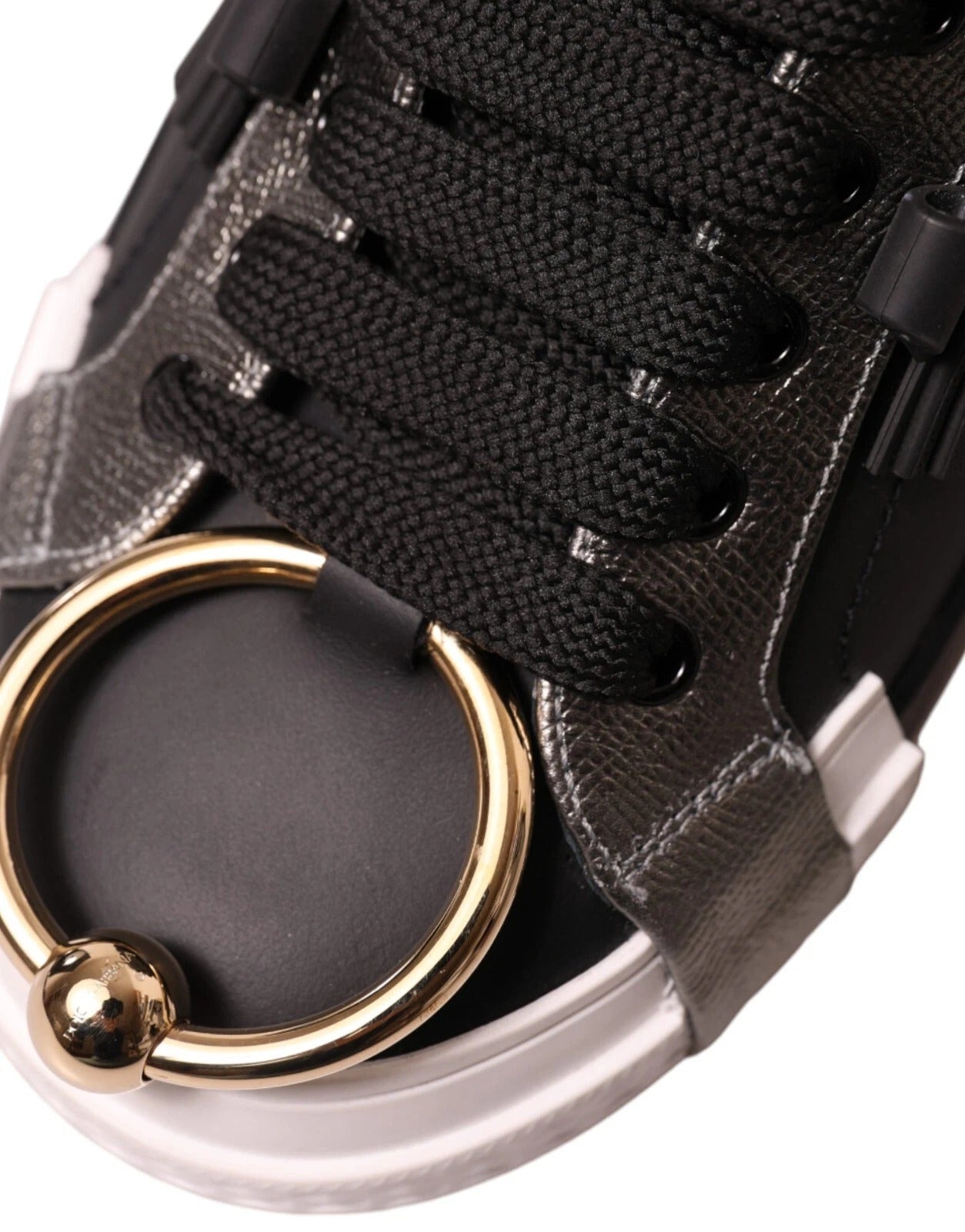 Gold ring on black shoe lace