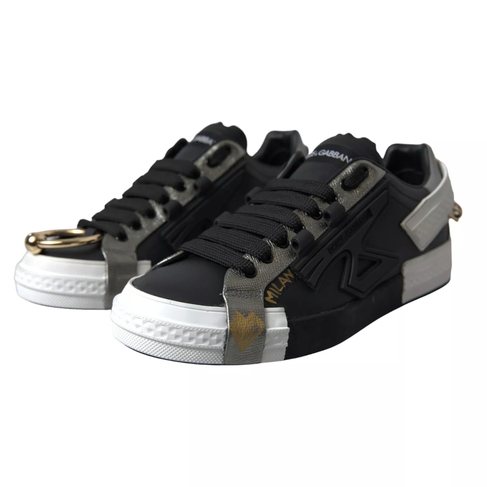 Pair of black sneakers with white laces and gold accents