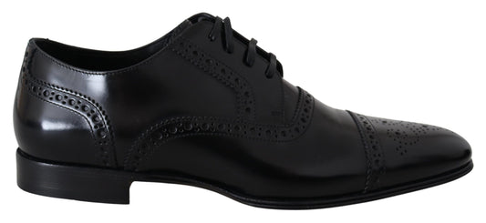 Pair of black dress shoes with laces and a small heel