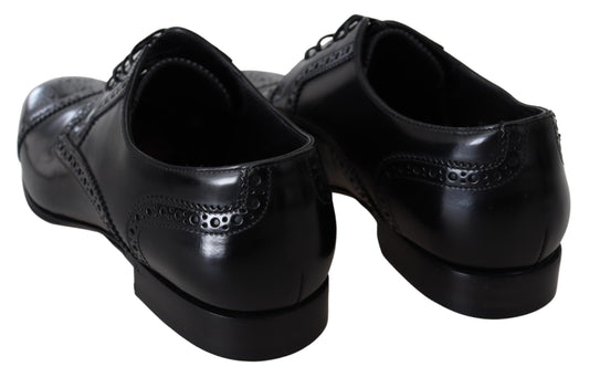 Pair of black dress shoes with laces and a small heel