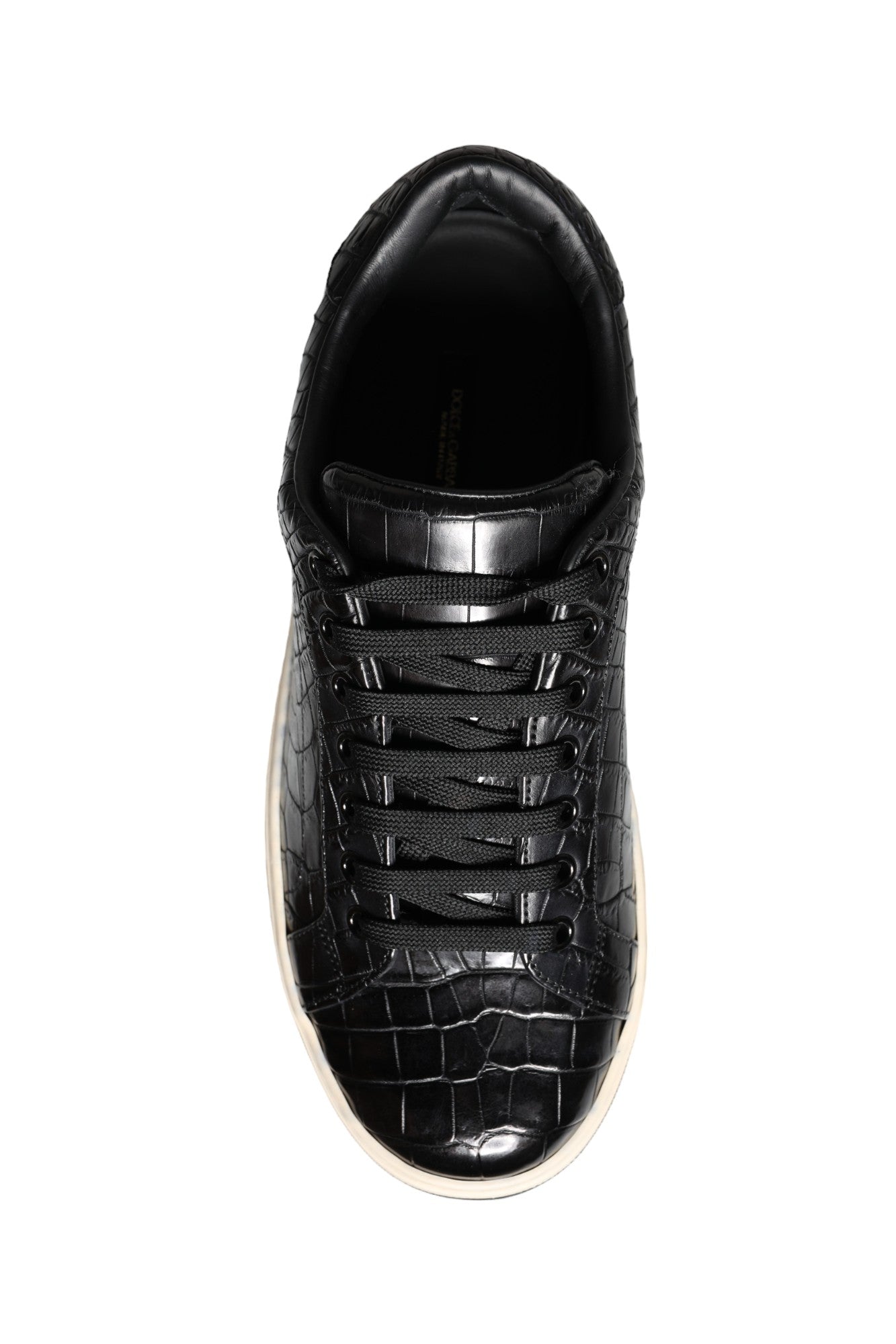 Black and white sneaker with a crocodile skin texture on the side