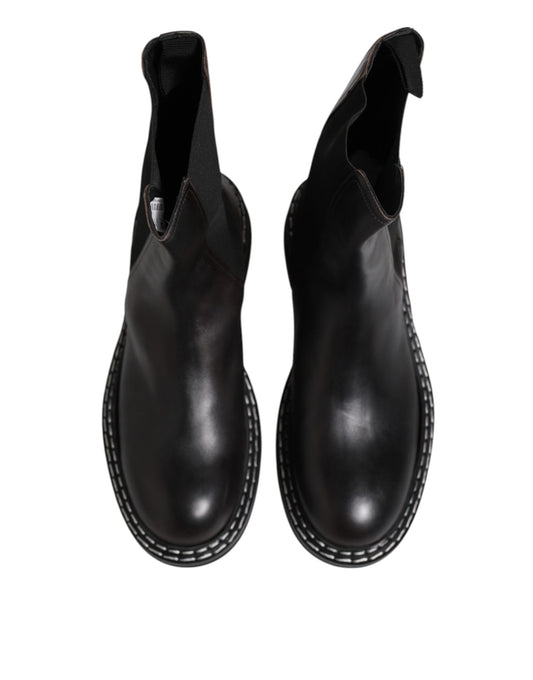 Pair of black leather boots with laces and stitching details