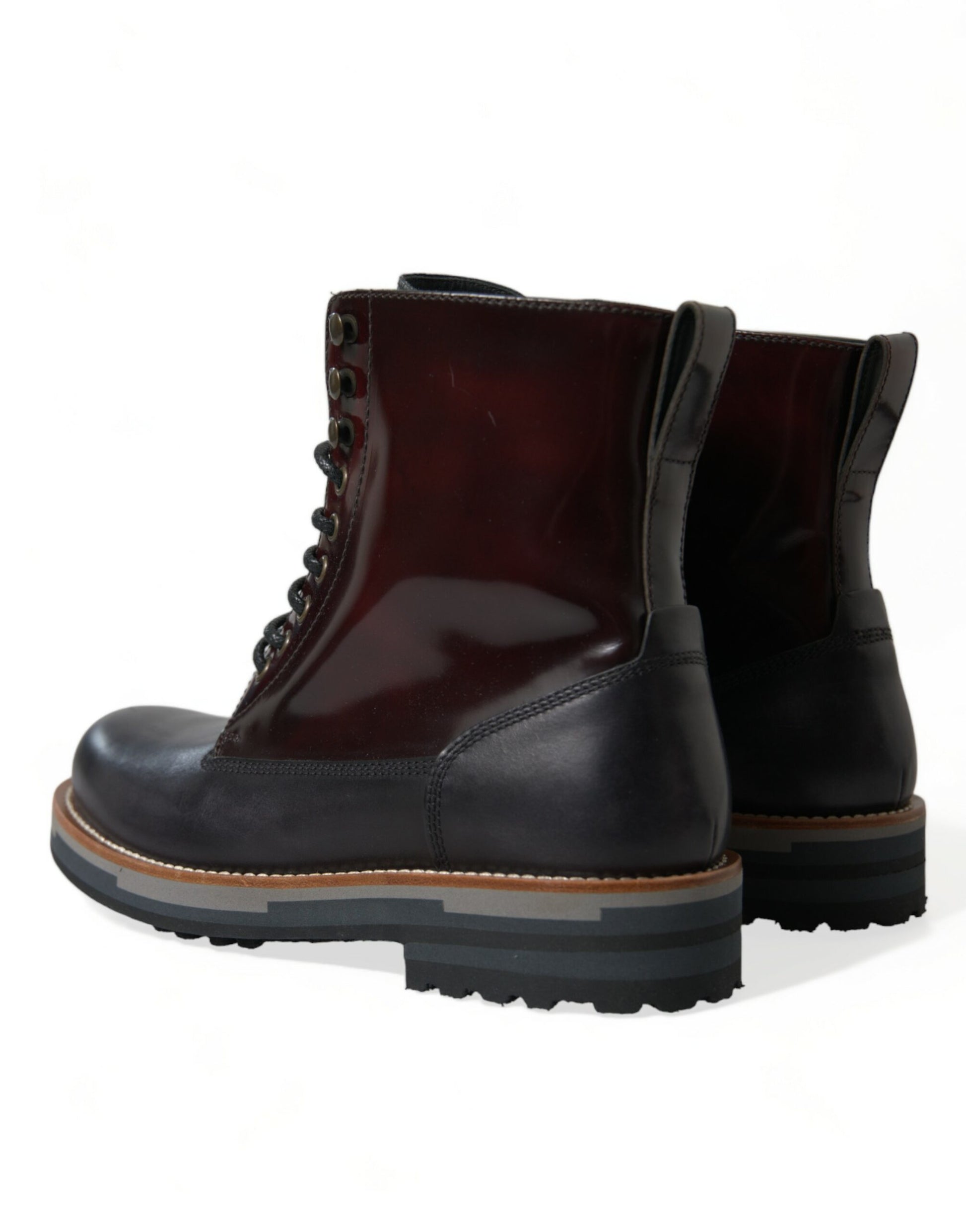 Pair of black rubber boots with laces and a pull tab on top