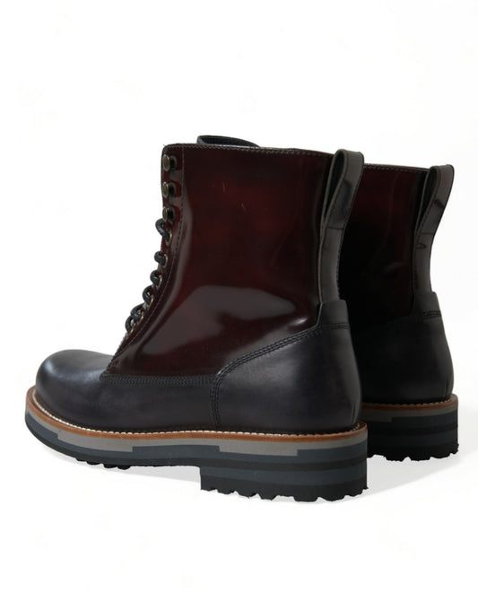 Pair of black rubber boots with laces and a pull tab on top
