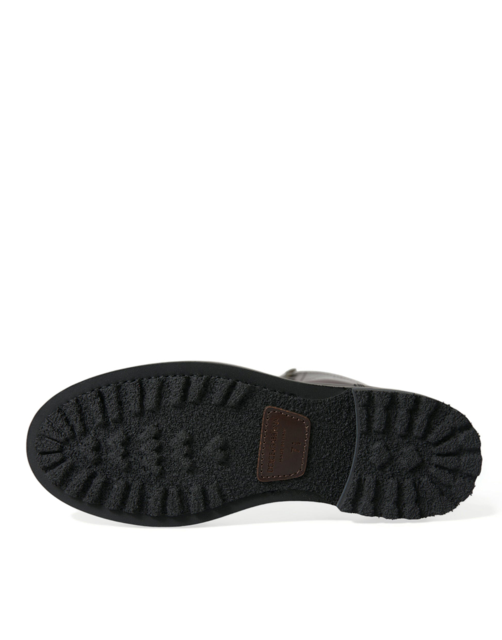 Black leather boot with rubber sole and brown strap across top