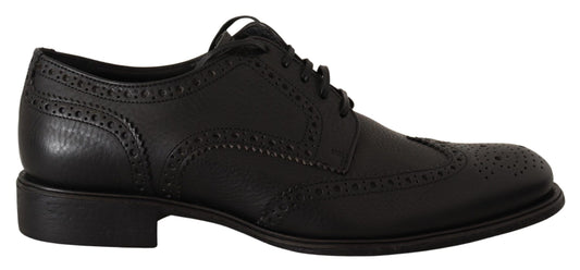 Pair of black leather shoes with laces and a small heel