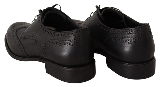 Pair of black dress shoes with laces and a small heel