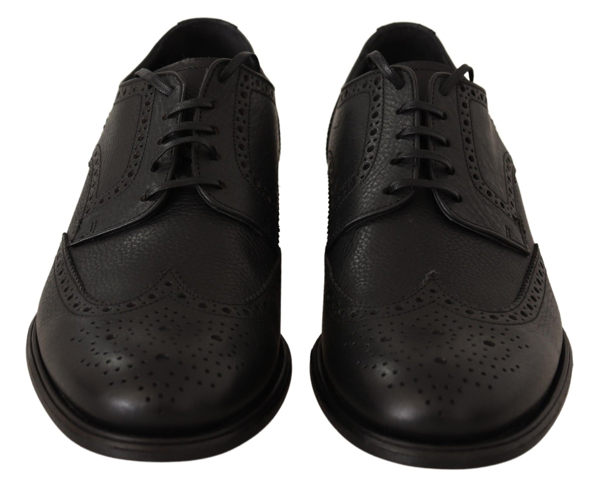 Pair of black leather dress shoes with laces and perforated design on soles