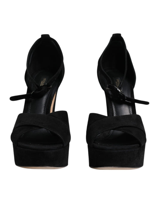 Pair of black high heel shoes with bow detailing