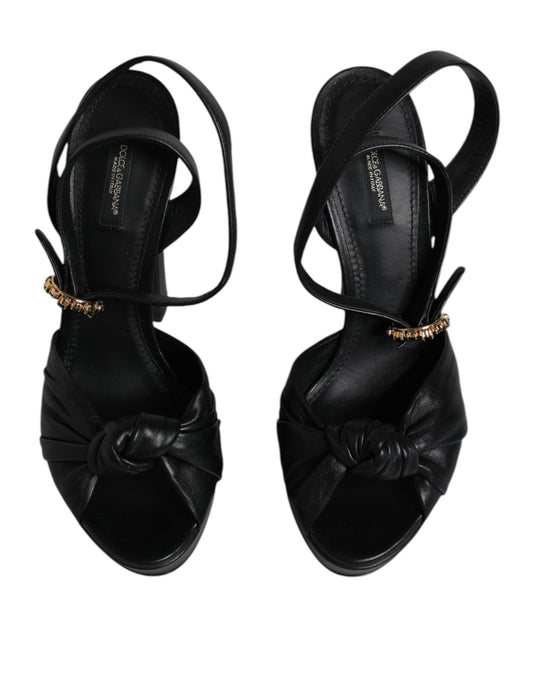 Pair of black strappy heels with gold accents